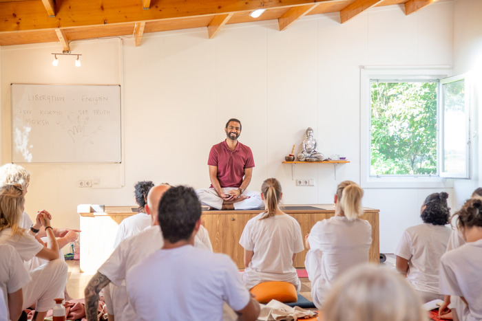 Yoga teacher smiling with students in class