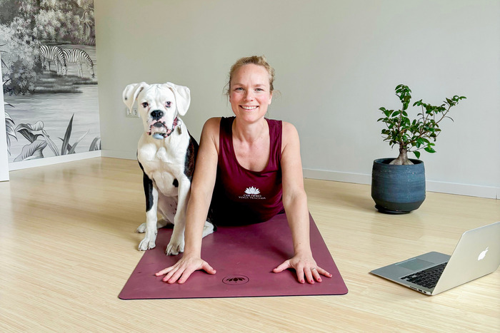 Yoga teacher trainer leading a virtual class from her studio