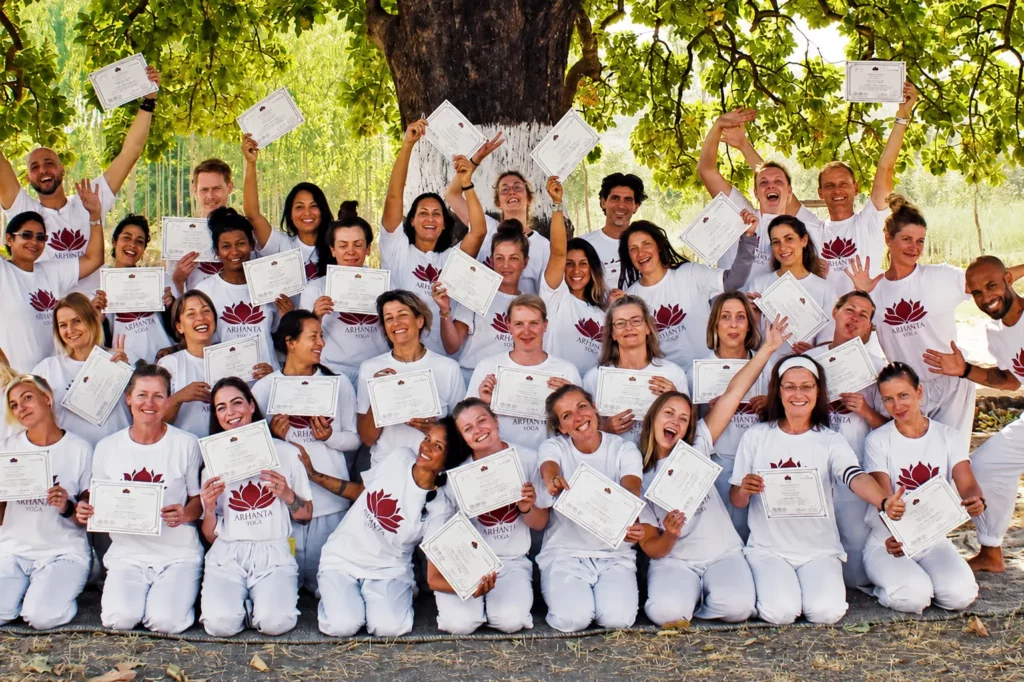 Graduates of the 200 hour yoga teacher training in India holding certificates