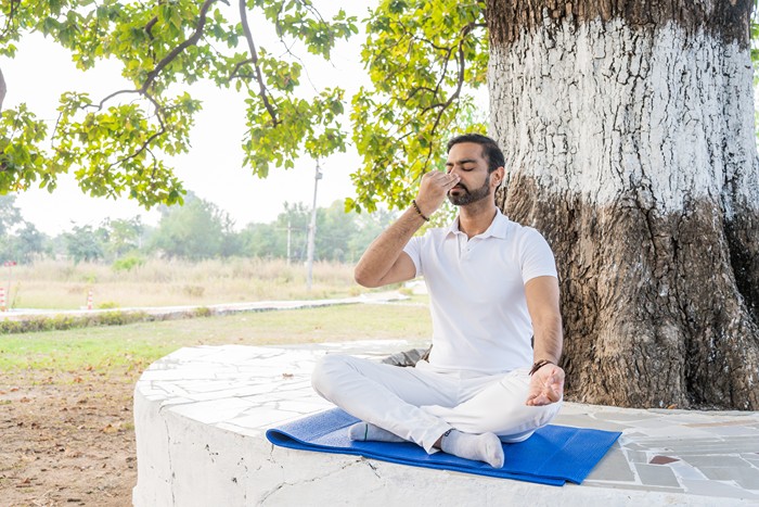 Yoga teacher practicing Nadi Shodhana before beginning an asana practice