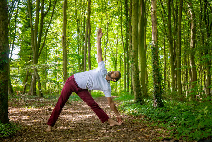 Yoga teacher self-practice at sunrise in a peaceful natural setting