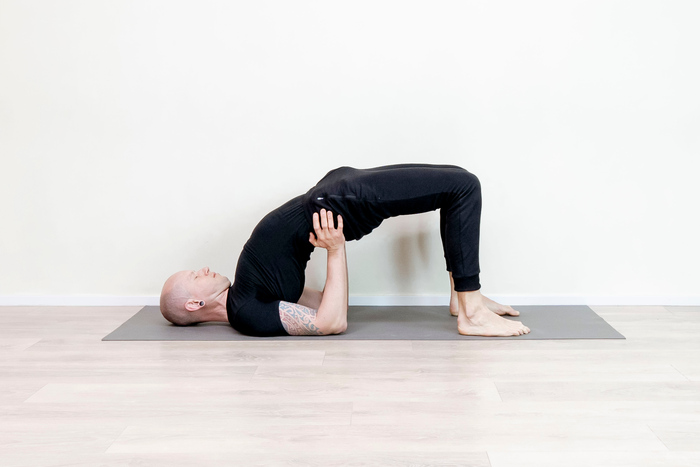 Yoga teacher demonstrating the Half Bridge pose
