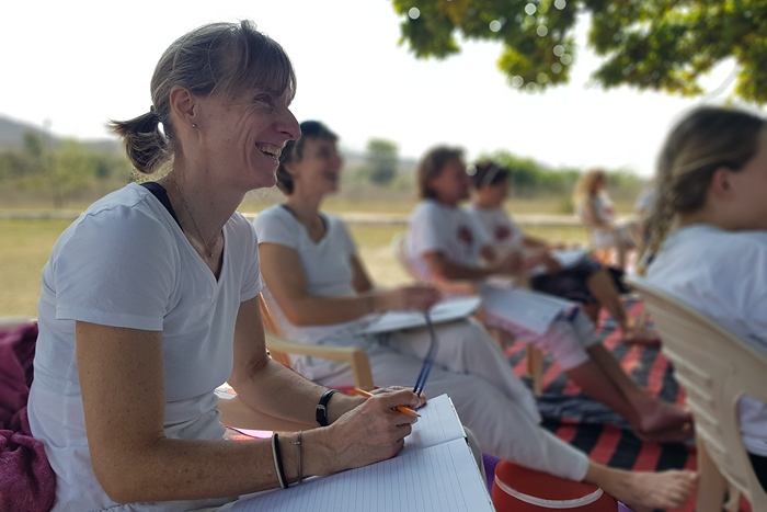 YTT students enjoying an outdoor session, discussing yoga beyond poses