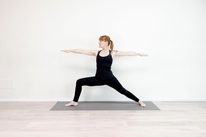 Woman practicing Triangle Pose during self-practice