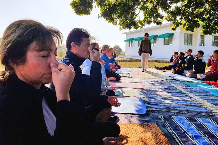 Yogic breathing exercises outdoors- group session